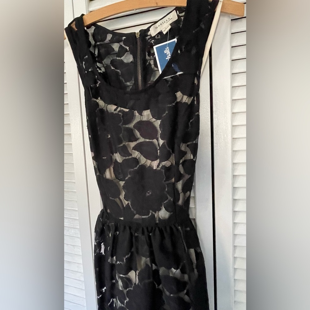 Beautiful knee length black laced dress with cream liner